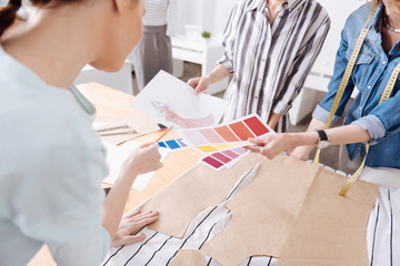 Designers choosing colour for a new dress