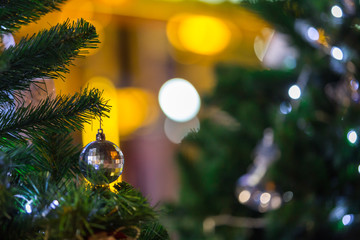 christmas tree and decorations on color bokeh background