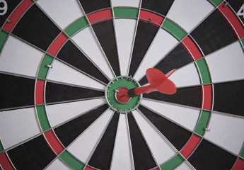 target red arrow on center of dartboard. concept business goal to marketing success.