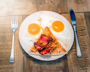 English breakfast with fried eggs, bacon and toasts