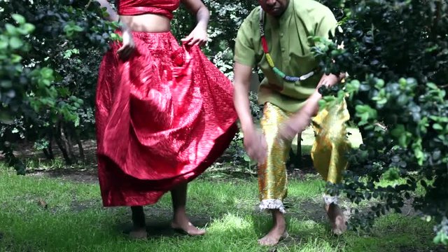 Father and adult daughter wearing traditional Brazilian clothing dancing together