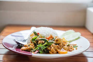 Rice topped with stir-fried pork and basil