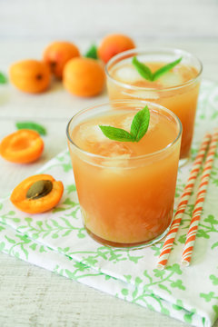 Apricot juice with ice cubes and apricots.
