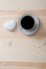 white coffee cup and gingerbread on wooden desk