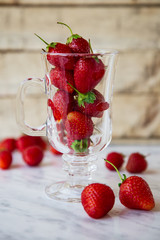 Fresh red juicy strawberries in a glass.