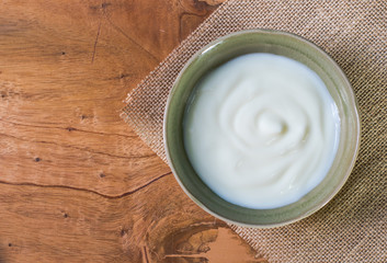 Natural yogurt  on wooden table top view