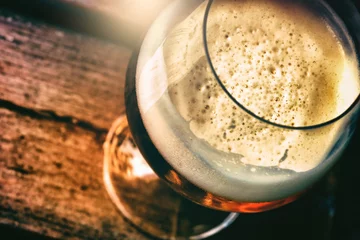 Foto op Plexiglas Glass of fresh beer in rustic pub, top view © Grecaud Paul