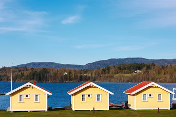 Colorful cabins with lake and mountain background