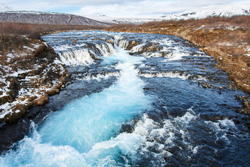 Blue water fall along river,Bruarfoss waterfall