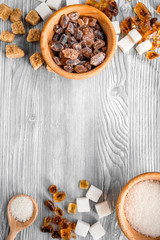 lumps of sugar with bowls sweet set on light table background top view mockup