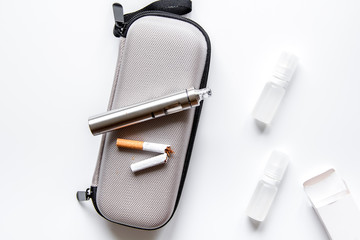 concept of electronic cigarette on white background top view