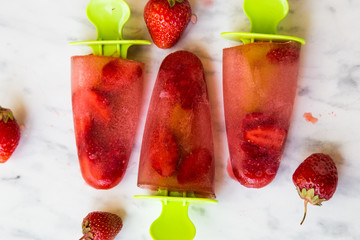 Strawberry ice cream on a marble table.