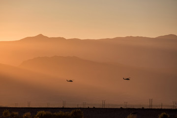 silhouette of helicopter with sunset.