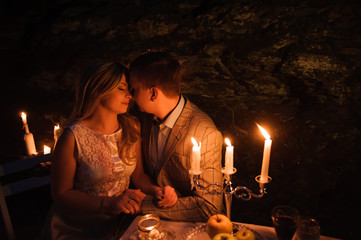 young couple enjoying a romantic dinner by candlelight, outdoor
