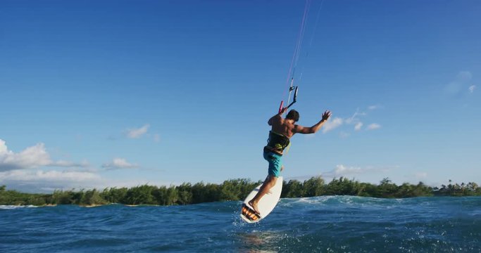 Young Man Kite Surfing in Slow Motion Big Air on Surfboard