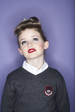 Portrait of rouged school girl looking up