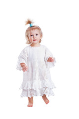 Cute small baby girl in hand made lace dress walking towards camera