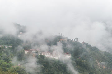 Fototapeta na wymiar View of Trongsa Dzong with foggy hills, Bumthang, Bhutan, Asia.