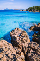 Clear amazing azure coloured sea water with gtanote rocks in Capriccioli beach, Sardinia, Italy