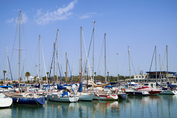 Fototapeta na wymiar Boat and yacht on a bright sunny day in the seaport of Marina de las Dunas, Guardamar del Segura, Alicante, Spain.