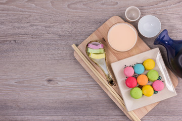 Sweet colorful macaroons on a wood background