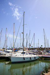 Boat and yacht on a bright sunny day in the seaport of Marina de las Dunas, Guardamar del Segura, Alicante, Spain.