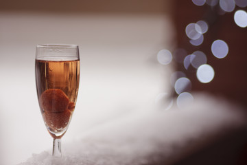  Champagne with strawberries on a background of lanterns
