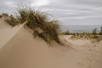 Sand Dune Background. Sand dune topped with dune grass on the shores of Lake Michigan in Silver Lake State Park.
