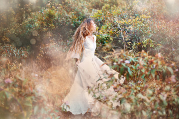 sensual boho woman in white dress outdoors