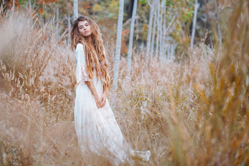 sensual boho woman in white dress outdoors