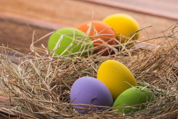 Naklejka na ściany i meble Easter eggs in nest on old wooden background
