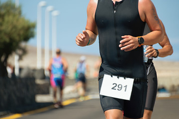 Running triathlon athlete man,running on triathlon race on sunny days