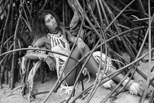 Attractive wild boho woman at beach. Native american style