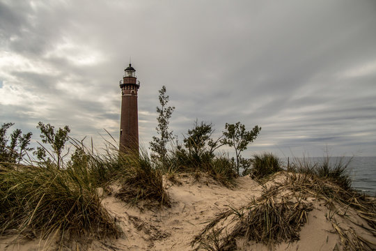 Lake Michigan Lighthouse. Little Sable Lighthouse on the shores of Lake Michigan surrounded by sand dunes and dune grass. Silver Lake State Park.
