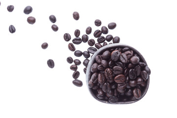 coffee beans in ceramic cup isolated in white background (focus coffee beans on floor)