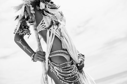 Attractive wild boho woman at beach. Native american style 