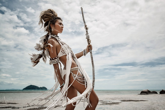 Attractive wild boho woman at beach. Native american style
