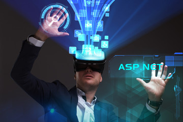 Business, Technology, Internet and network concept. Young businessman working in virtual reality glasses sees the inscription: ASP.NET