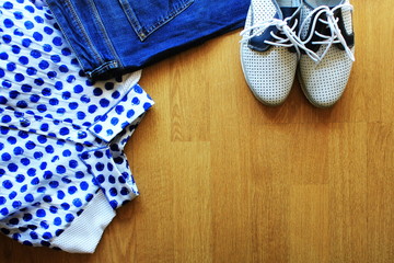 Collection of women's clothes. Jeans, shoes, bluose. Top view