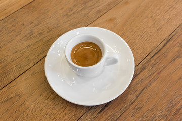 Coffee in white cup on wood table
