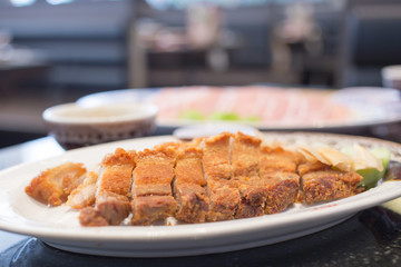 Crispy pork cut into pieces on the plate