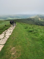 People walking along Mam Tor path, Peak District, Derbyshire, UK