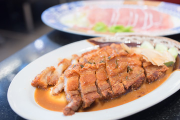 Crispy pork cut into pieces on the plate