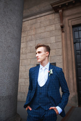 Groom on his wedding day. man in tuxedo and tie posing