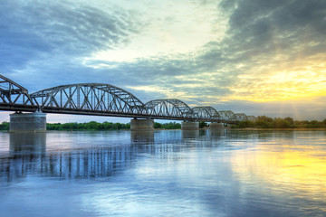 Fototapeta na wymiar Sunset over Vistula river in Grudziadz bridge, Poland