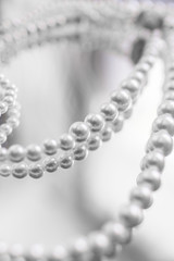 Necklace of white pearls on a mirror surface