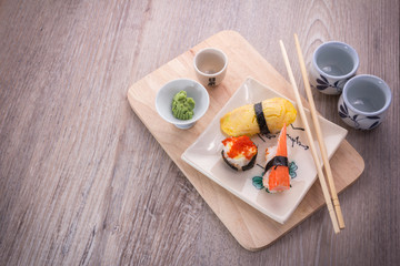 Fototapeta na wymiar sushi set on old wood table