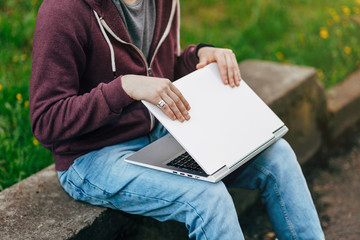 Handsome Young Man Working on Laptop Outside His Office, Freelance Concept