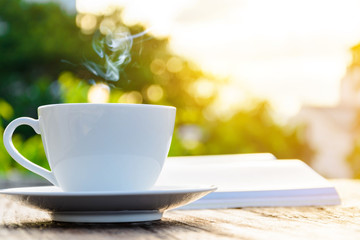 coffee cup clock and news paper on old wooden table