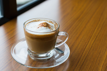 Cappuccino cup on wooden table